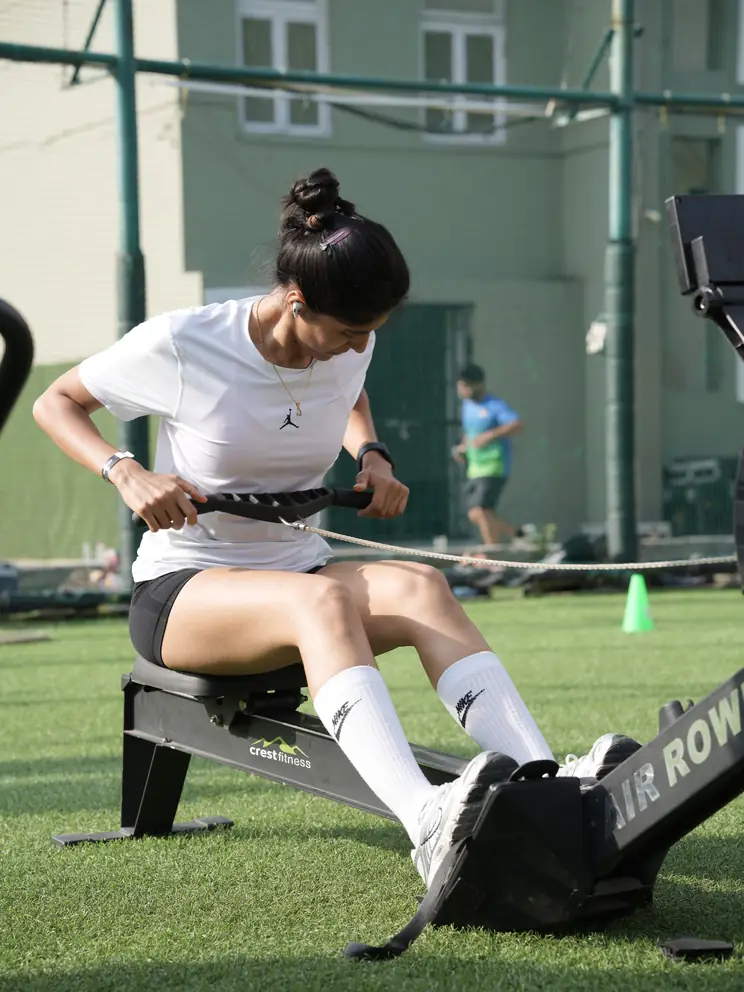 A participant driving through a rowing station on the turf