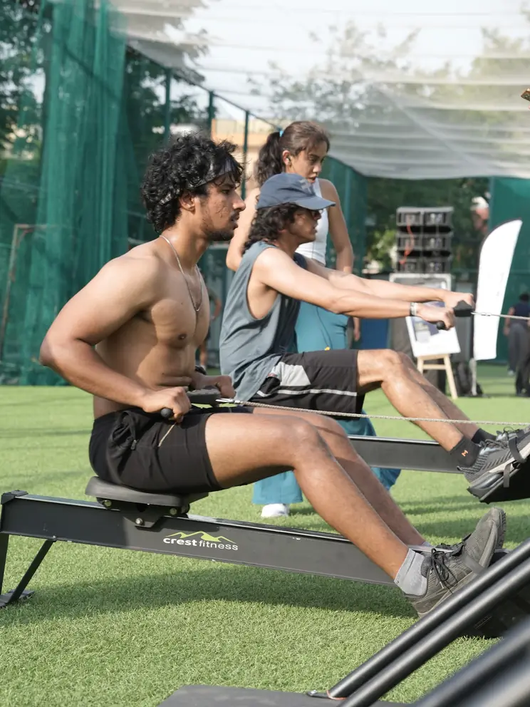 Two participants rowing side by side at adjacent stations